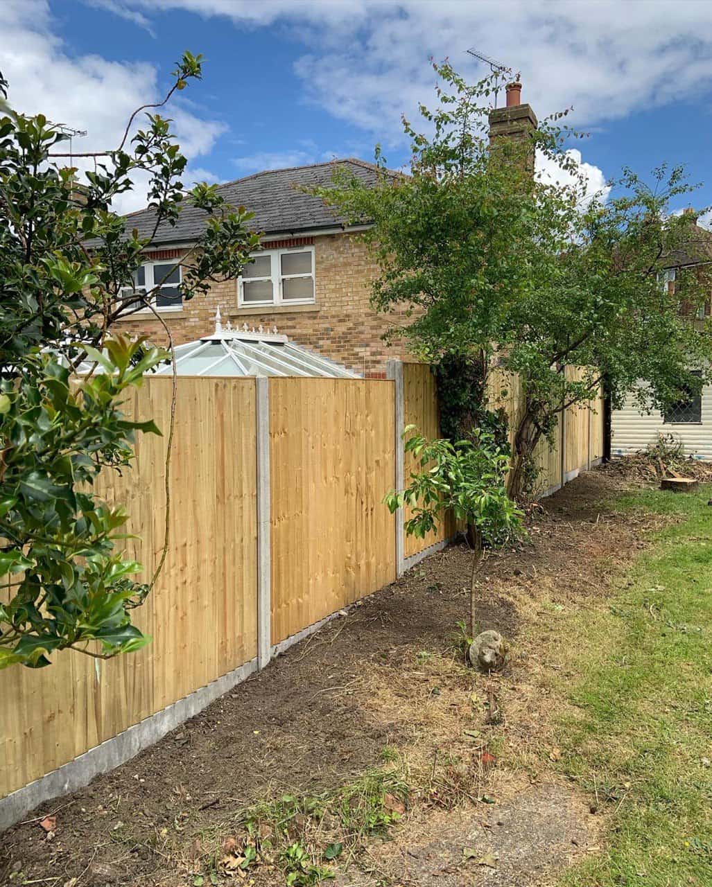 This is a photo of fence panels installed in a residential garden using concrete posts and gravel boards. Installed by Fast Fix Fencing Swanley
